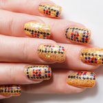 Red and black dotted design on gold basecoat.