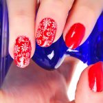 Red nail polish with a floral print.