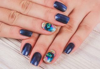 Shiny fingernails with an eye motif.